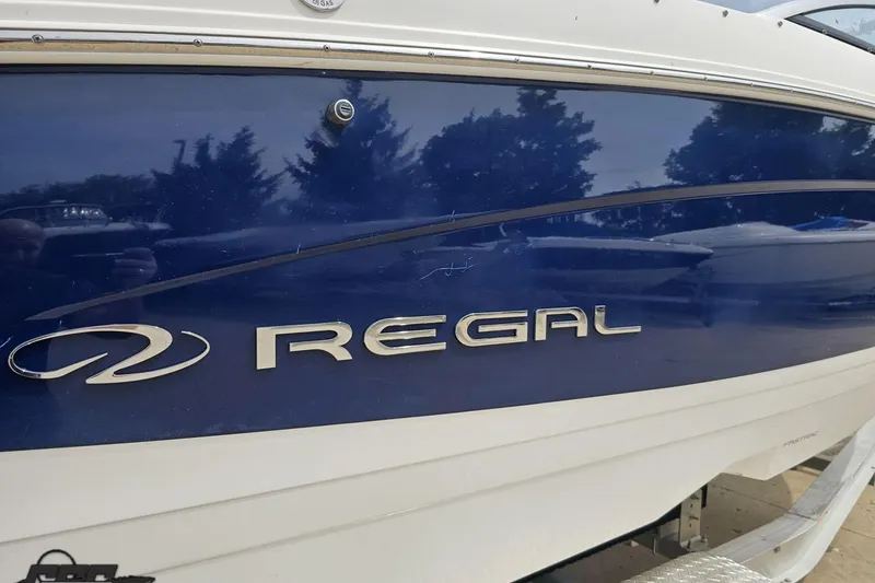 Slide: The Image of 2021 Regal LX4 boat with blue and white exterior detailing. - 9