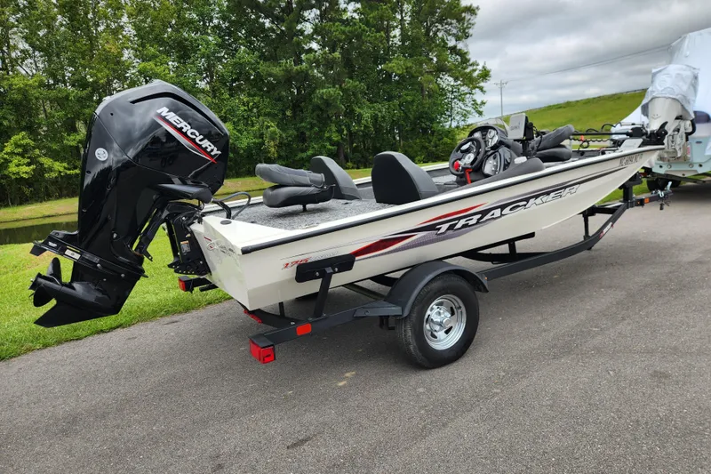 Slide: The Image of 2024 Tracker Pro Team 175 TXW boat with Mercury engine on trailer. - 2