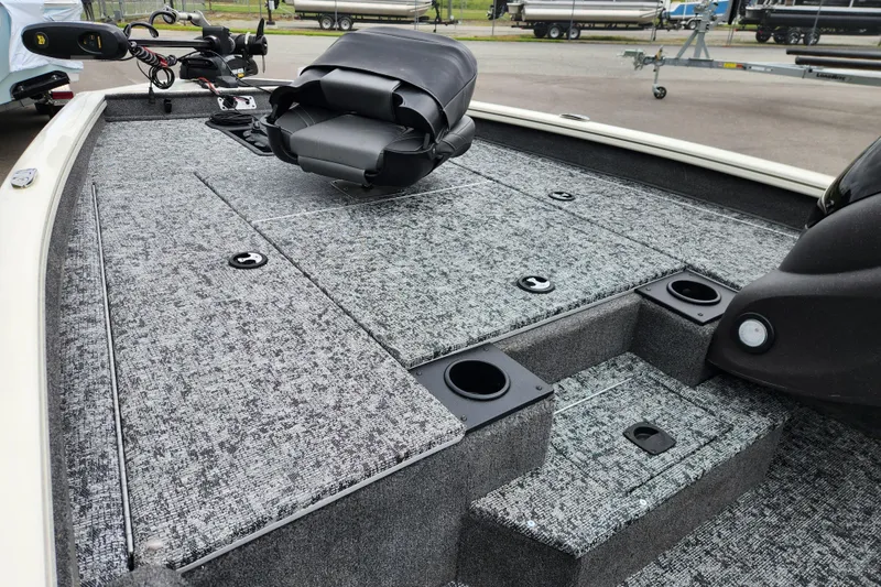 Slide: The Image of 2024 Tracker Pro Team 175 TXW boat interior with carpeted deck and seating. - 7