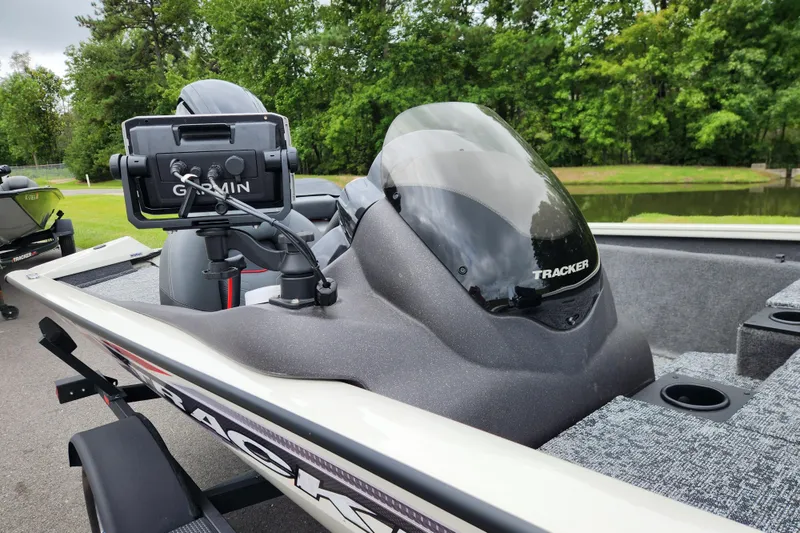 Slide: The Image of 2024 Tracker Pro Team 175 TXW boat with Garmin device, parked near a pond. - 9