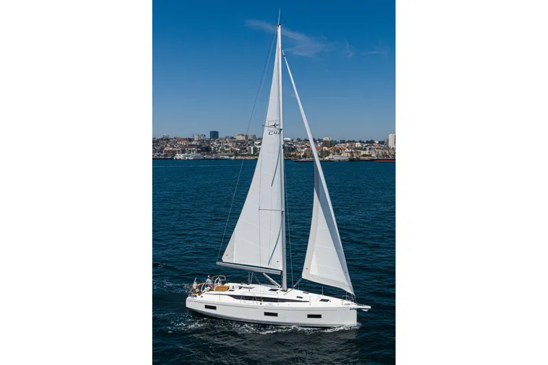 Slide: The Image of 2023 Bavaria C42 sailboat cruising on open water under clear blue skies. - 11
