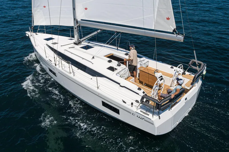Slide: The Image of 2023 Bavaria C42 sailing yacht cruising on open water, featuring sleek design and spacious deck. - 18