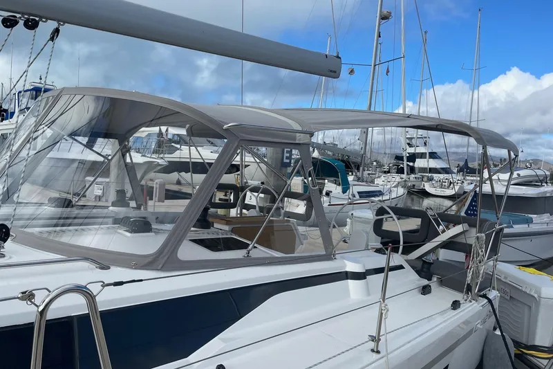 Slide: The Image of 2023 Bavaria C42 yacht docked at marina, featuring sleek design and modern canopy. - 2