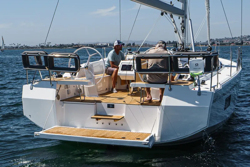 Slide: The Image of 2023 Bavaria C42 yacht sailing with two people on deck, sunny day, calm waters. - 21