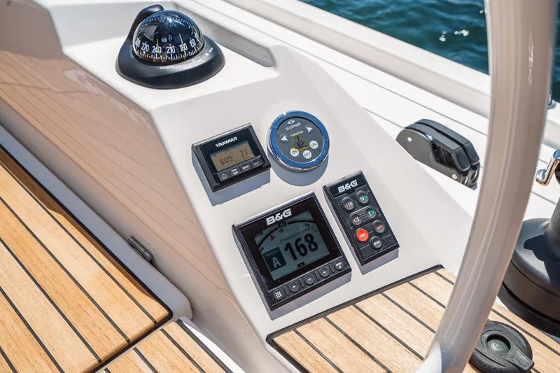 Slide: The Image of Cockpit of 2023 Bavaria C42 yacht with navigation instruments and wooden deck. - 26