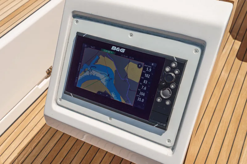 Slide: The Image of Bavaria C42 2023 yacht navigation system on wooden deck, displaying nautical map. - 27
