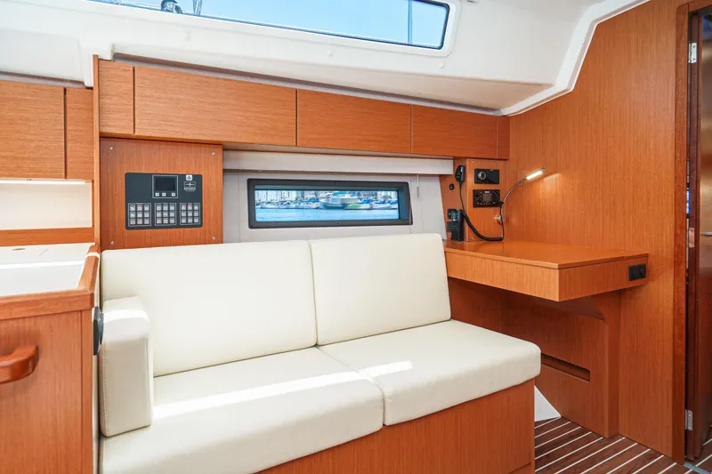 Slide: The Image of Interior of 2023 Bavaria C42 yacht with modern wood finish and white seating. - 37