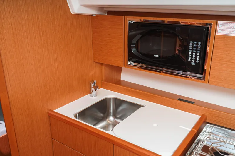 Slide: The Image of Modern kitchen area in 2023 Bavaria C42 yacht with sink and microwave. - 41