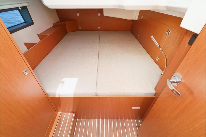 Slide: The Image of 2023 Bavaria C42 yacht cabin with wooden interior and comfortable bedding. - 47