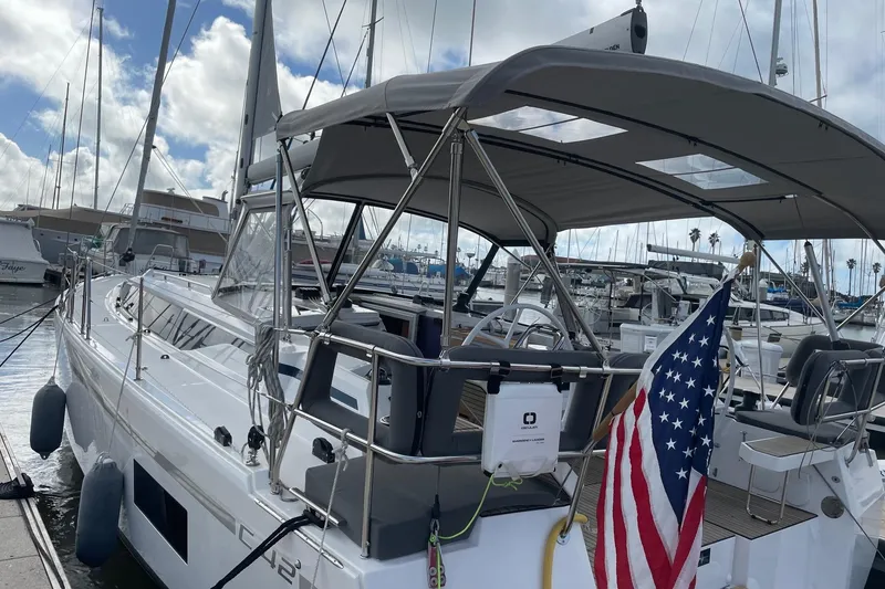 Slide: The Image of 2023 Bavaria C42 yacht docked at marina with American flag. - 6
