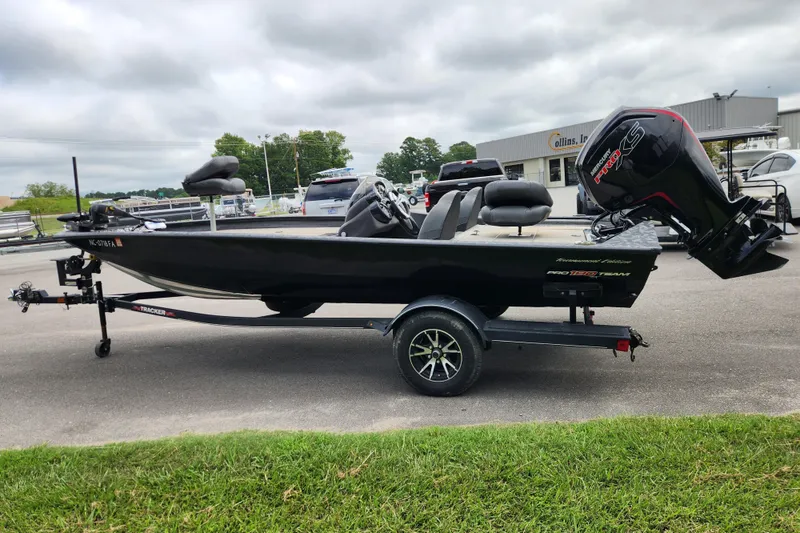 Slide: The Image of 2023 Tracker Pro Team 190 TX boat on trailer, parked outdoors. - 4