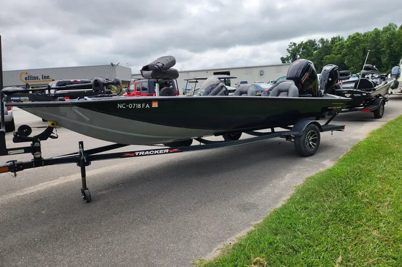 Slide: The Image of 2023 Tracker Pro Team 190 TX boat on trailer, parked outdoors near a building. - 5