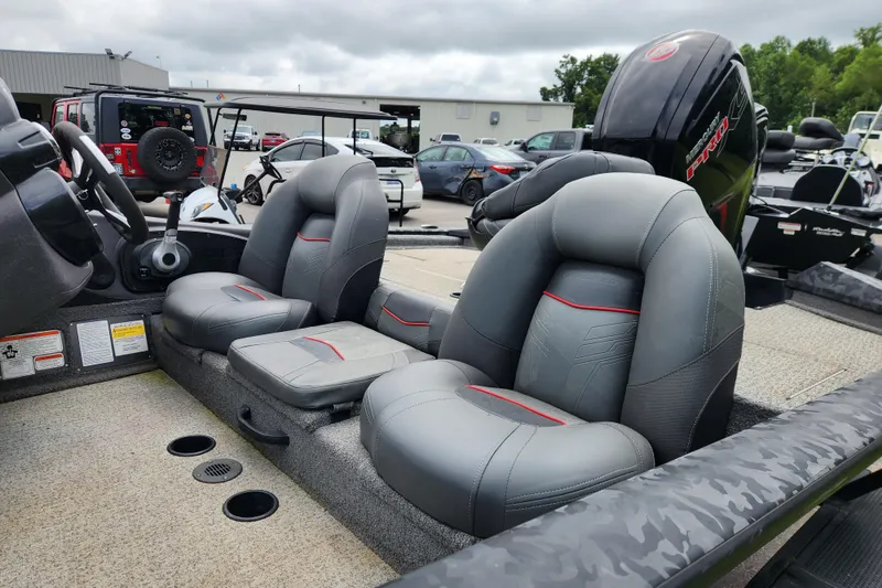 Slide: The Image of 2023 Tracker Pro Team 190 TX boat interior with gray seats and steering wheel. - 8