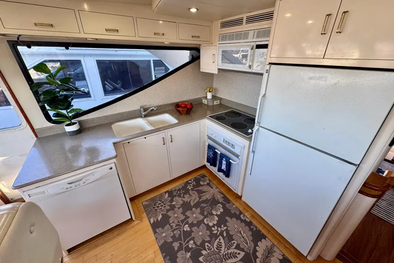 Slide: The Image of Modern kitchen in 1995 Queenship 62 Pilothouse Motor Yacht with appliances and large window. - 13