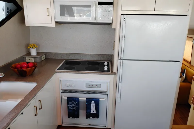 Slide: The Image of Kitchen area of 1995 Queenship 62 Pilothouse Motor Yacht with modern appliances. - 14