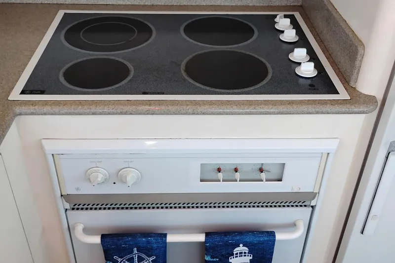 Slide: The Image of Stovetop and oven in 1995 Queenship 62 Pilothouse Motor Yacht kitchen. - 15