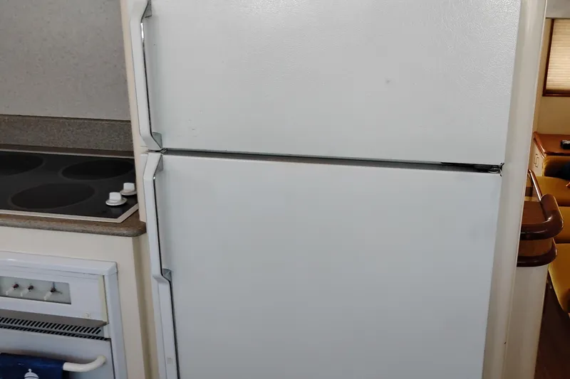 Slide: The Image of Kitchen area of 1995 Queenship 62 Pilothouse Motor Yacht with refrigerator and stove. - 16