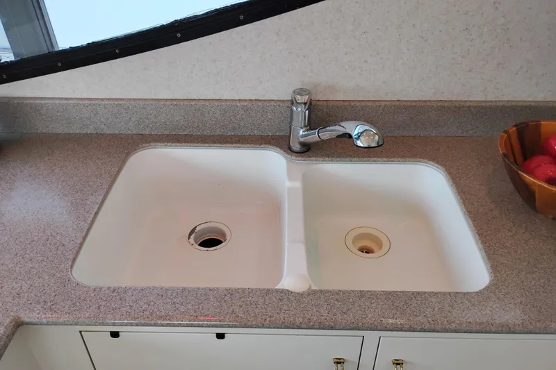 Slide: The Image of Kitchen sink and faucet on 1995 Queenship 62 Pilothouse Motor Yacht. - 18