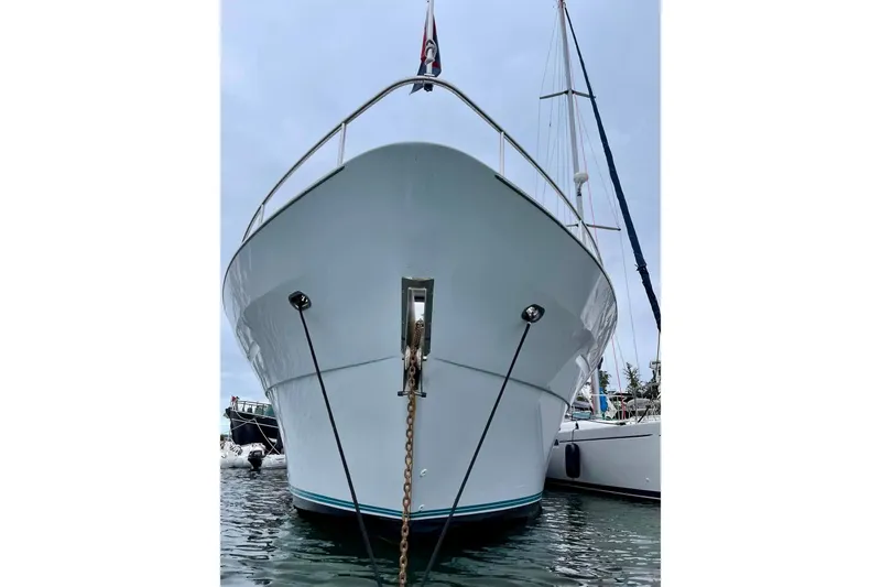 Slide: The Image of Queenship 62 Pilothouse Motor Yacht 1995, docked front view with anchor chain. - 2