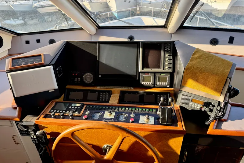 Slide: The Image of Pilothouse of 1995 Queenship 62 Motor Yacht with navigation controls and steering wheel. - 21