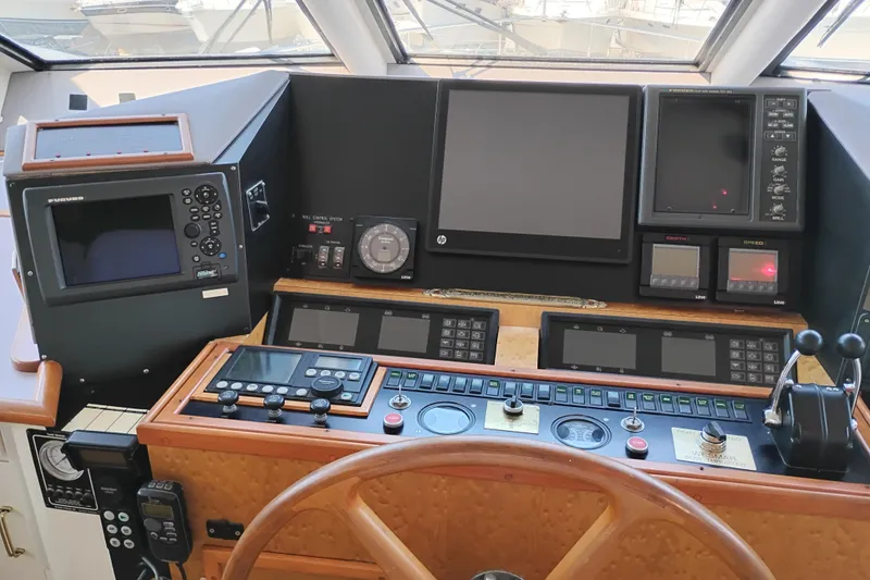 Slide: The Image of Control panel of a 1995 Queenship 62 Pilothouse Motor Yacht with navigation equipment. - 22