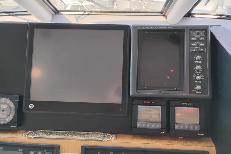 Slide: The Image of Control panel of 1995 Queenship 62 Pilothouse Motor Yacht with navigation displays. - 24