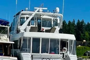 Slide: The Image of 1995 Queenship 62 Pilothouse Motor Yacht docked, featuring spacious deck and modern design. - 3