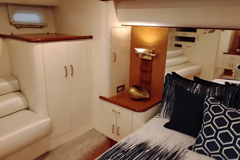 Slide: The Image of Luxurious interior of 1995 Queenship 62 Pilothouse Motor Yacht bedroom with elegant decor. - 35