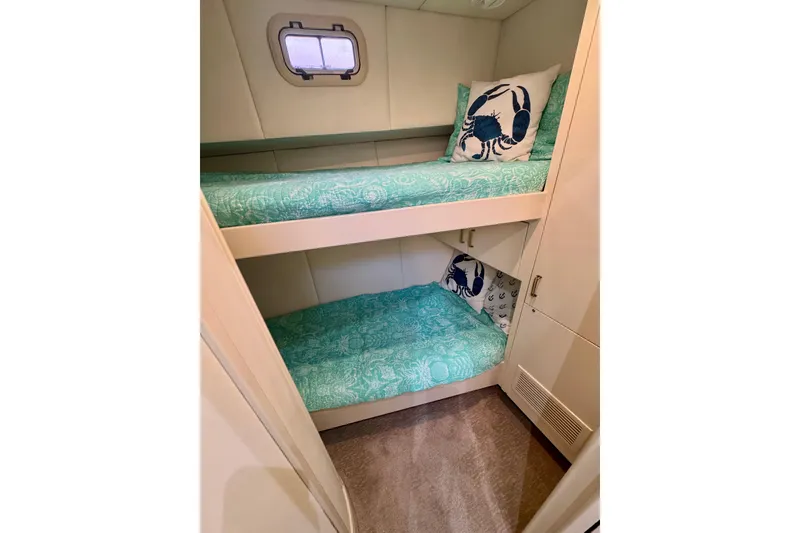 Slide: The Image of Bunk beds with teal bedding in 1995 Queenship 62 Pilothouse Motor Yacht cabin. - 41