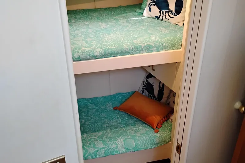 Slide: The Image of Bunk beds with teal bedding in 1995 Queenship 62 Pilothouse Motor Yacht cabin. - 42