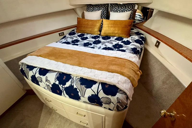 Slide: The Image of Luxurious bedroom in 1995 Queenship 62 Pilothouse Motor Yacht with floral bedding. - 43