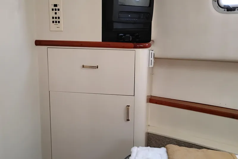 Slide: The Image of Interior of 1995 Queenship 62 Pilothouse Motor Yacht with cabinet and TV. - 45