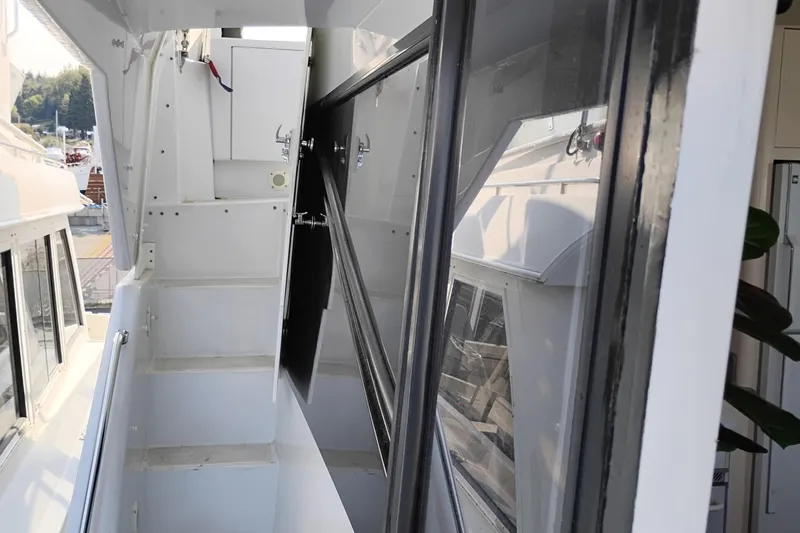 Slide: The Image of 1995 Queenship 62 Pilothouse Motor Yacht side deck with railing and windows. - 47
