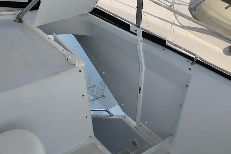 Slide: The Image of Interior view of 1995 Queenship 62 Pilothouse Motor Yacht, showcasing sleek white design. - 48