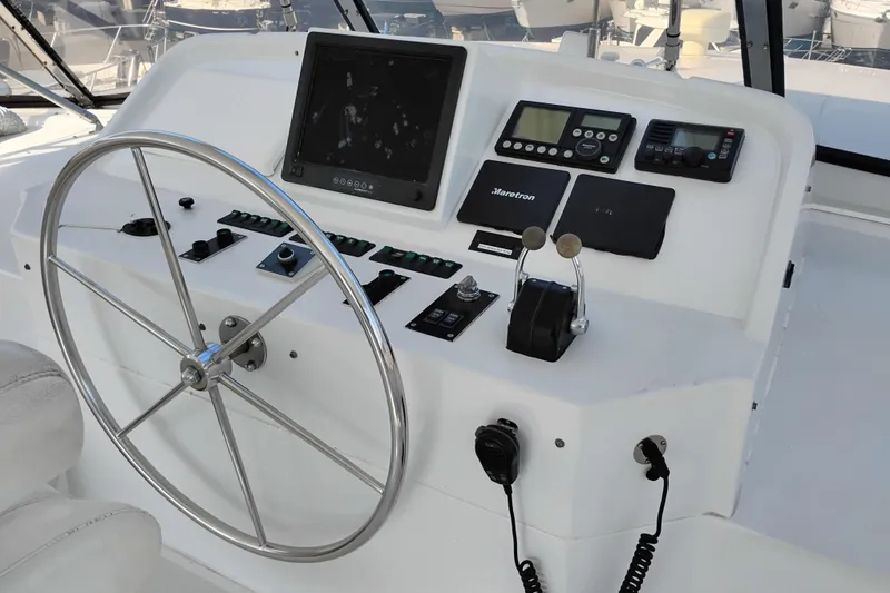 Slide: The Image of Helm of 1995 Queenship 62 Pilothouse Motor Yacht with steering wheel and navigation controls. - 51