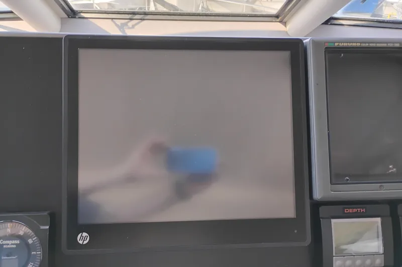 Slide: The Image of 1995 Queenship 62 Pilothouse Motor Yacht dashboard with HP monitor and navigation instruments. - 54