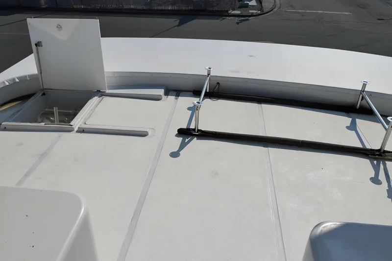 Slide: The Image of 1995 Queenship 62 Pilothouse Motor Yacht deck with open hatch and railing. - 59