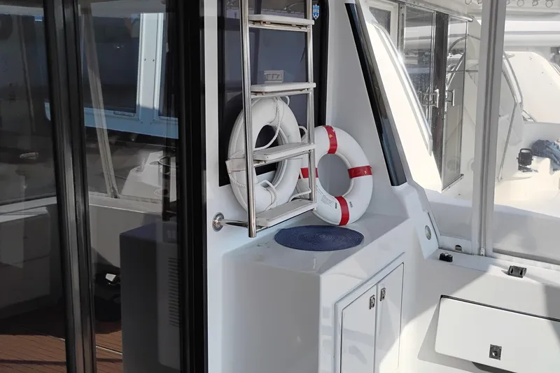 Slide: The Image of 1995 Queenship 62 Pilothouse Motor Yacht interior with life rings and safety equipment. - 60