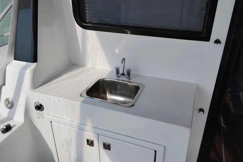 Slide: The Image of Stainless steel sink on 1995 Queenship 62 Pilothouse Motor Yacht deck. - 61