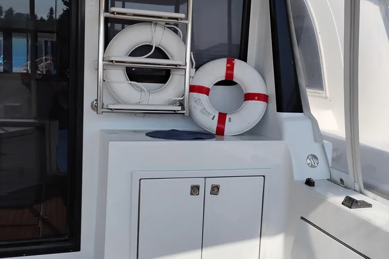 Slide: The Image of Life rings on 1995 Queenship 62 Pilothouse Motor Yacht deck, safety equipment. - 62