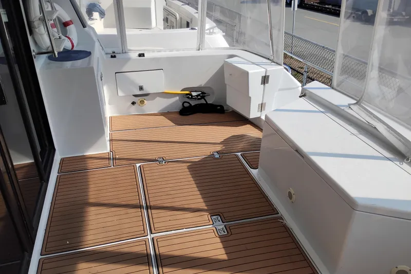 Slide: The Image of Spacious deck of 1995 Queenship 62 Pilothouse Motor Yacht with teak flooring. - 63