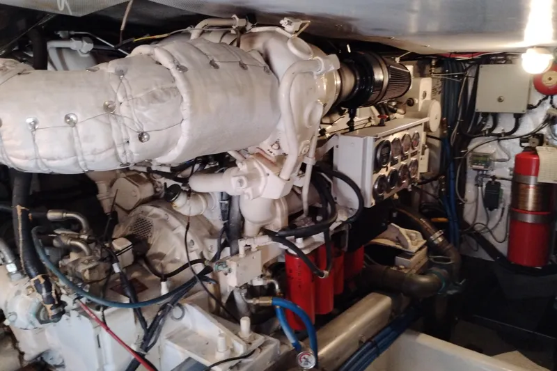 Slide: The Image of Engine room of a 1995 Queenship 62 Pilothouse Motor Yacht, showcasing machinery and equipment. - 65