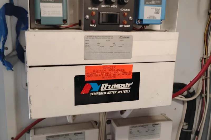 Slide: The Image of Electrical control panel on 1995 Queenship 62 Pilothouse Motor Yacht with warning labels. - 69