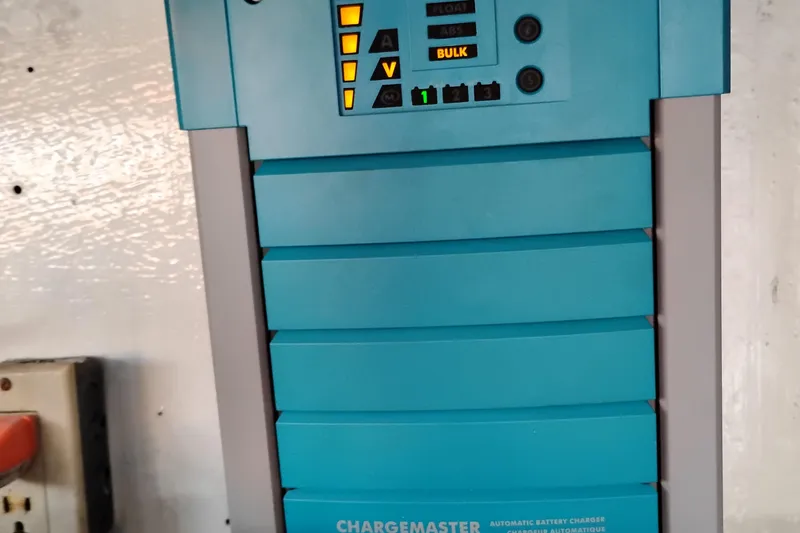 Slide: The Image of Battery charger panel on 1995 Queenship 62 Pilothouse Motor Yacht, displaying charge status. - 72