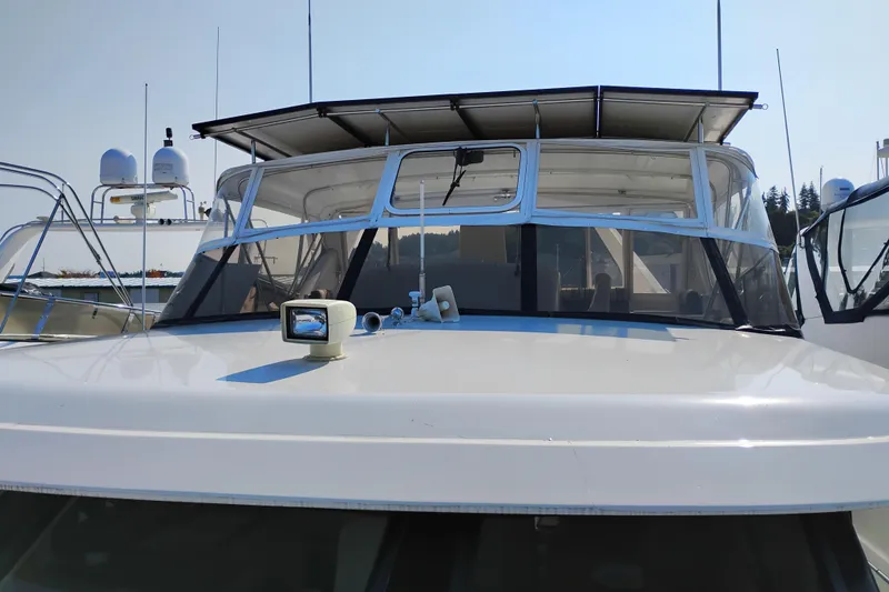 Slide: The Image of 1995 Queenship 62 Pilothouse Motor Yacht with sleek design and modern navigation equipment. - 77