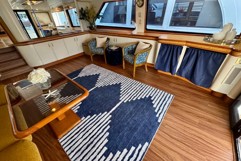 Slide: The Image of Luxurious interior of 1995 Queenship 62 Pilothouse Motor Yacht with elegant decor and seating. - 8