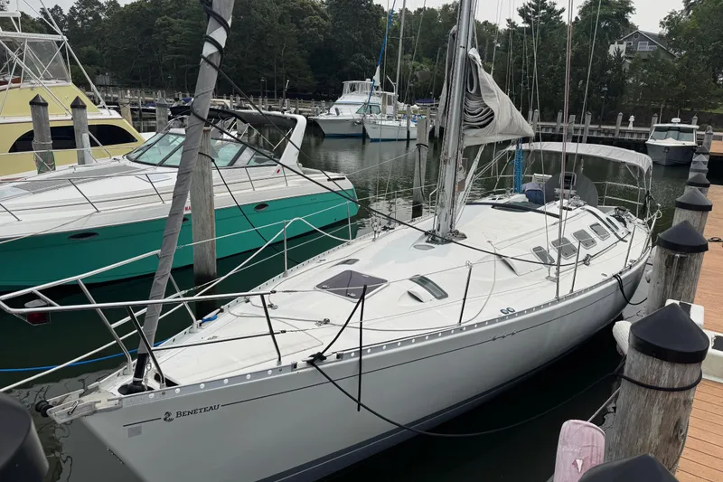 Slide: The Image of 1989 Beneteau First 41s5 sailboat docked at a marina with other boats. - 3