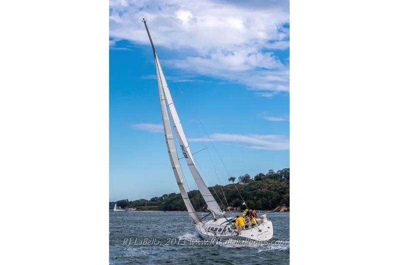 Slide: The Image of Sailing yacht Beneteau First 41S5, 1989 model, navigating under clear blue skies. - 42