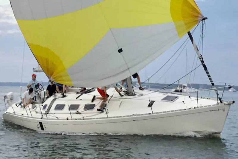 Slide: The Image of Sailing Beneteau First 41S5, 1989 model, with vibrant yellow and white sails on open water. - 38