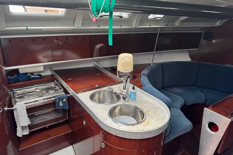 Slide: The Image of Interior of 1989 Beneteau First 41s5 yacht with kitchen and seating area. - 23